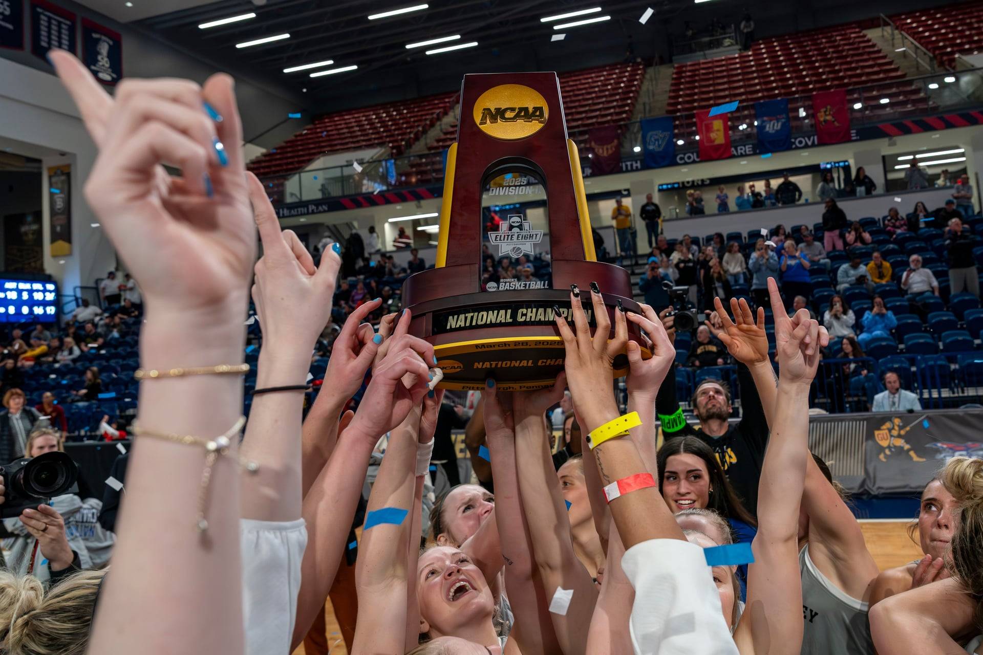 hands lifting up a national championship trophy